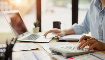 Businessman calculating finances at office desk. Concepts of finance management.